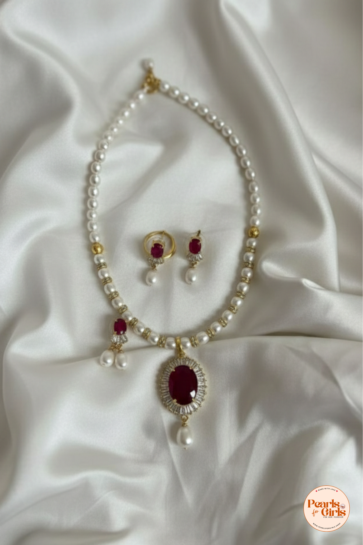 Classic pearl strand with ruby-toned centerpiece pendant
