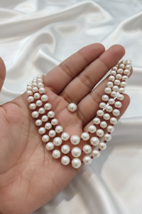 Multi-layered pearl strands with red bead