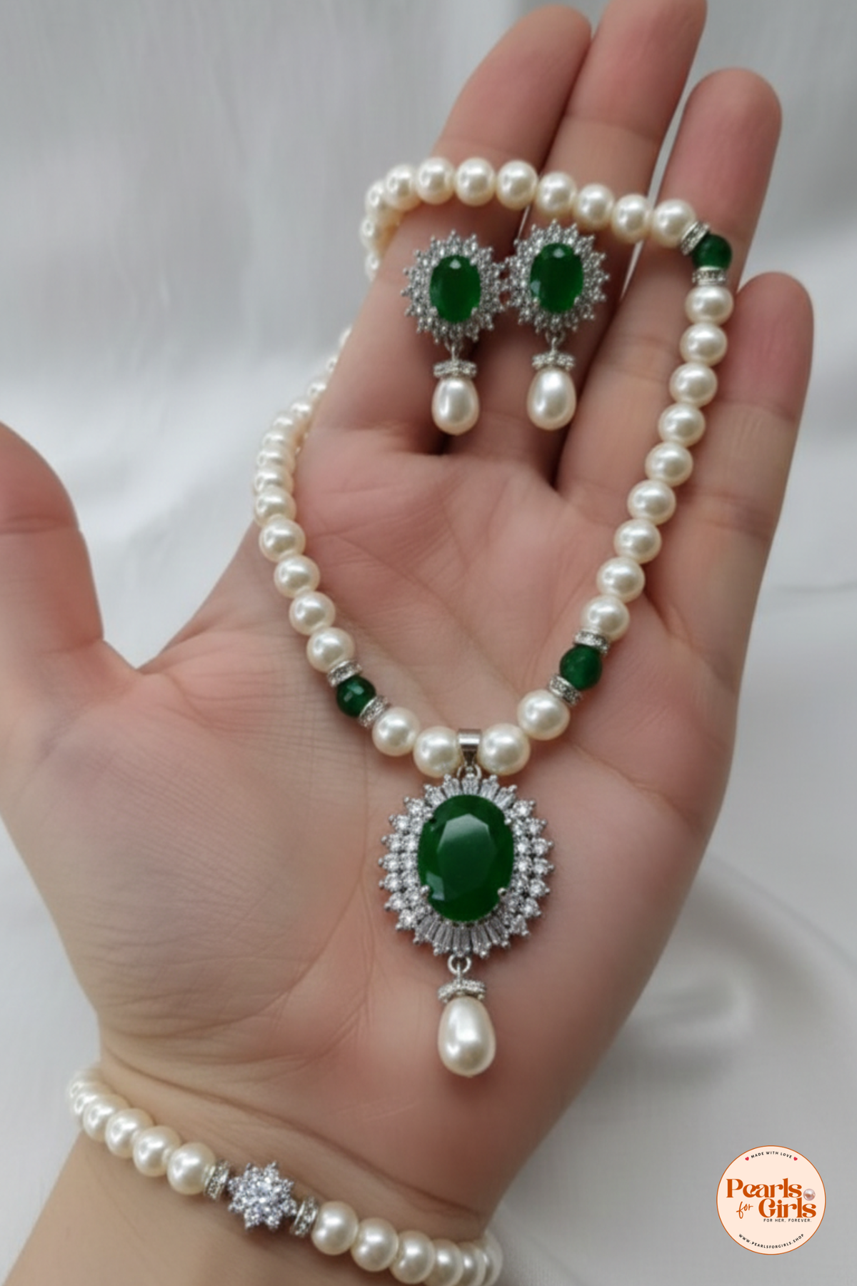Classic pearl strand with emerald green stone centre piece