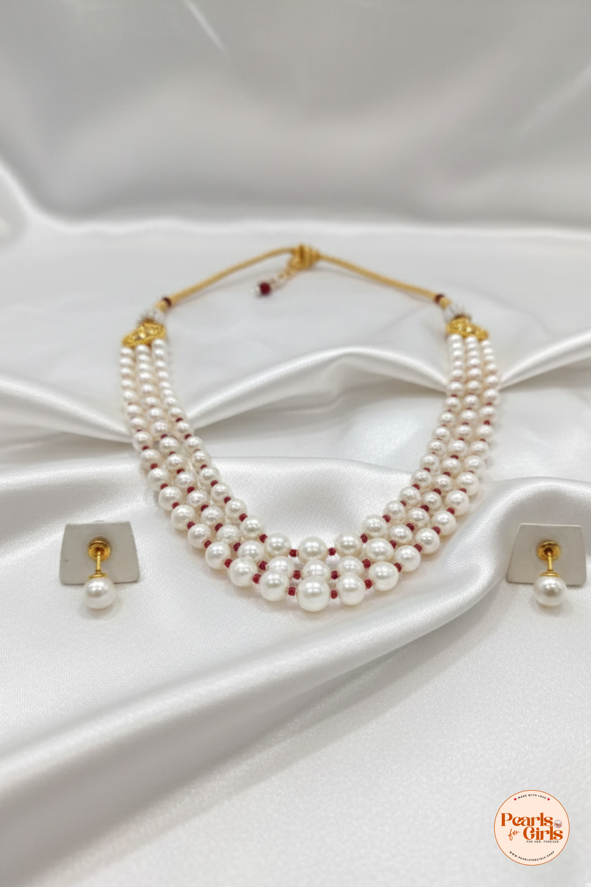 Multi-layered pearl strands with red bead